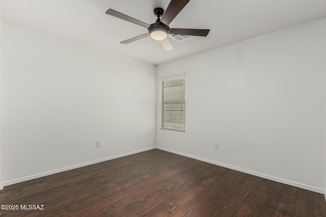 spare room with visible vents, a ceiling fan, baseboards, and dark wood-style flooring