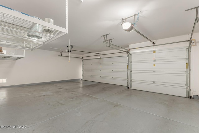 garage featuring a garage door opener and baseboards