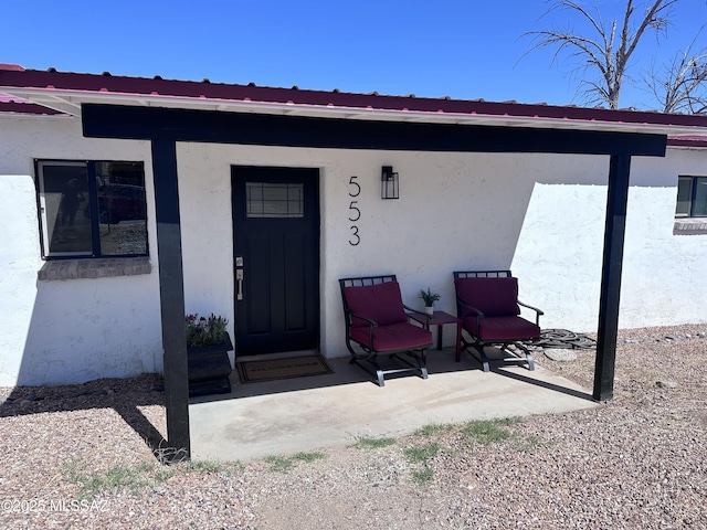 view of exterior entry with stucco siding