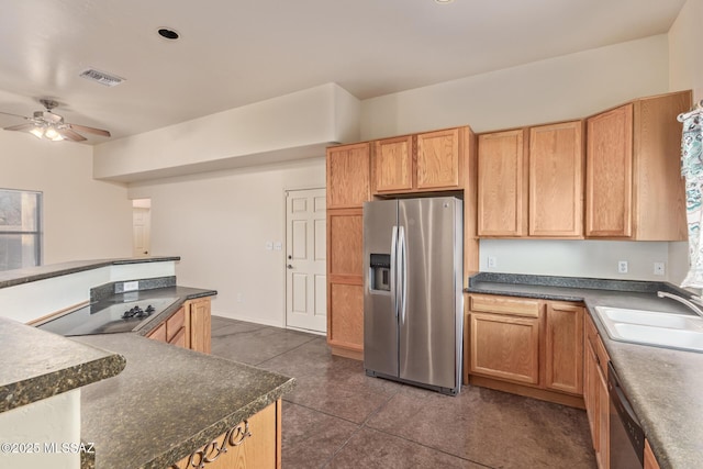 kitchen with dark countertops, visible vents, ceiling fan, appliances with stainless steel finishes, and a sink