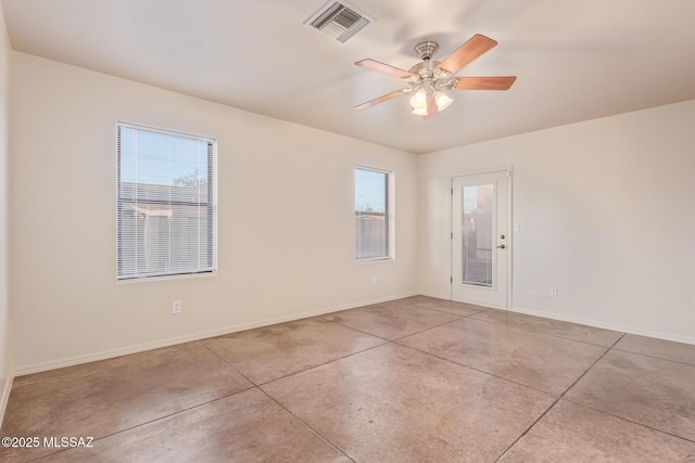 spare room with baseboards, visible vents, and concrete flooring