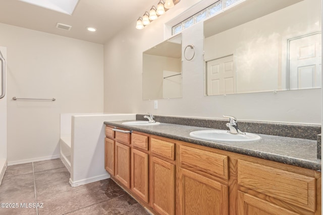 full bath with double vanity, visible vents, a garden tub, and a sink