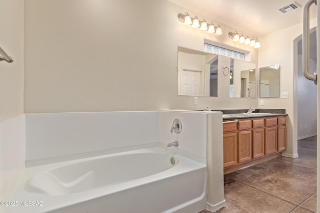 full bathroom featuring visible vents, a garden tub, a sink, double vanity, and baseboards