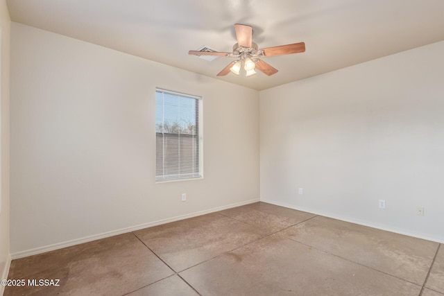 empty room featuring baseboards, concrete flooring, and ceiling fan