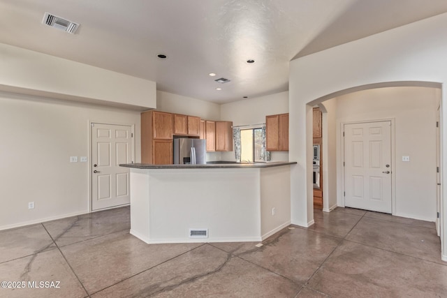 kitchen featuring finished concrete floors, appliances with stainless steel finishes, baseboards, and visible vents