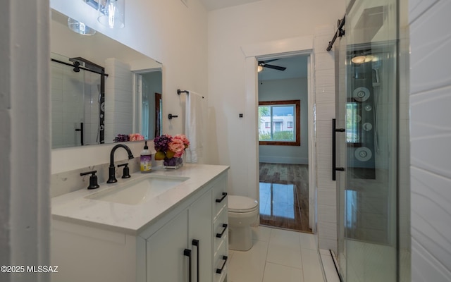 full bath with tile patterned floors, a shower stall, toilet, and vanity