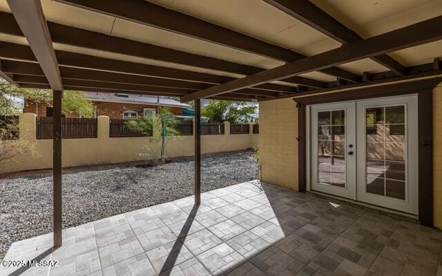 view of patio / terrace with french doors and fence