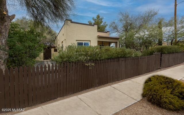 view of home's exterior featuring a fenced front yard and stucco siding