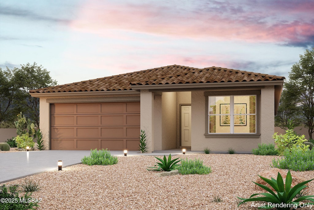 mediterranean / spanish-style home with concrete driveway, an attached garage, and stucco siding