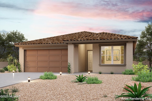 mediterranean / spanish-style home with concrete driveway, an attached garage, and stucco siding