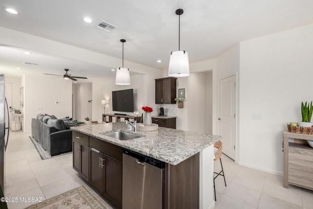 kitchen featuring visible vents, an island with sink, a sink, dark brown cabinets, and dishwasher