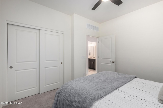 bedroom featuring light colored carpet, visible vents, a closet, and ceiling fan