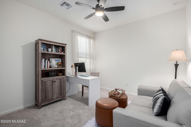 office area with visible vents, light colored carpet, baseboards, and ceiling fan