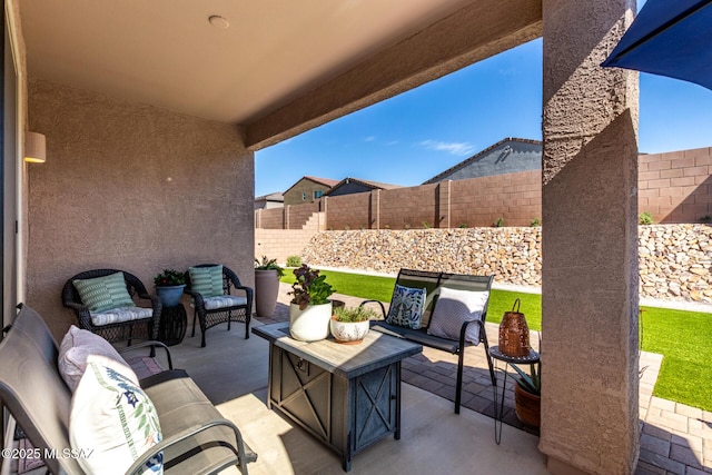 view of patio featuring outdoor lounge area and a fenced backyard