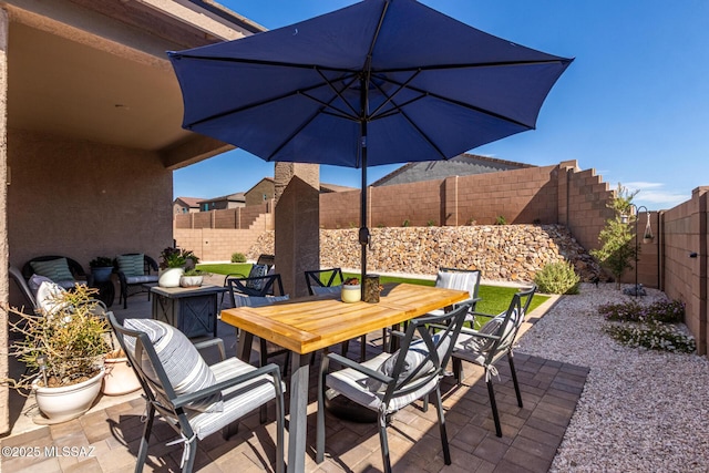 view of patio / terrace with outdoor dining space and a fenced backyard