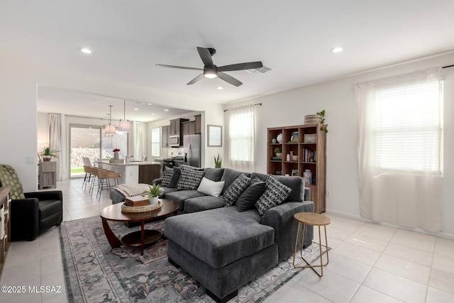 living room with light tile patterned floors, visible vents, and recessed lighting