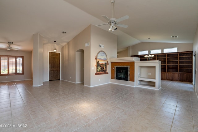 unfurnished living room featuring light tile patterned floors, visible vents, ceiling fan with notable chandelier, and a tile fireplace
