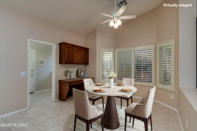 dining space with visible vents, baseboards, light tile patterned floors, high vaulted ceiling, and a ceiling fan