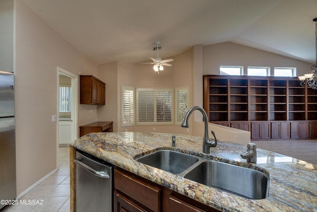 kitchen featuring a sink, lofted ceiling, dishwasher, and a wealth of natural light