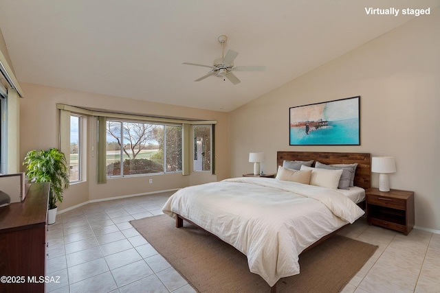 bedroom featuring lofted ceiling, light tile patterned floors, baseboards, and ceiling fan