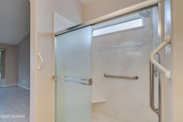 full bath featuring tile patterned flooring and a shower stall