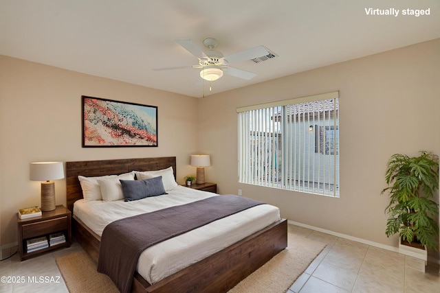 bedroom with visible vents, baseboards, light tile patterned flooring, and a ceiling fan
