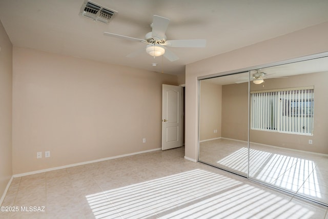 unfurnished bedroom with visible vents, baseboards, a closet, and tile patterned flooring