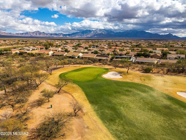 drone / aerial view featuring a mountain view, golf course view, and a residential view