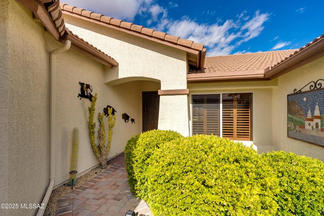 property entrance with stucco siding