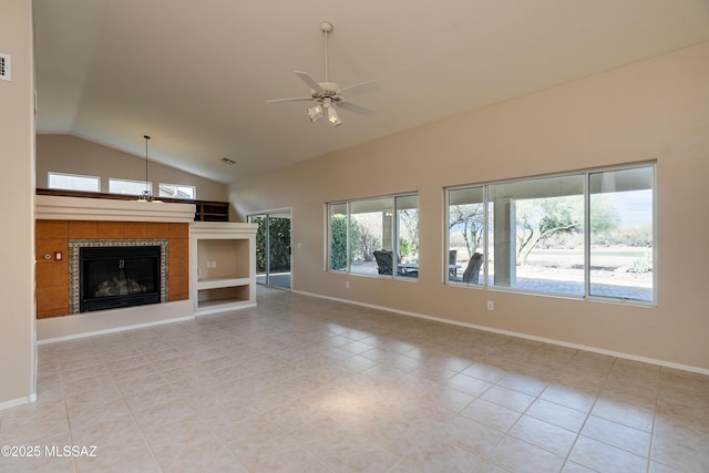 unfurnished living room featuring baseboards, lofted ceiling, a fireplace, and a ceiling fan