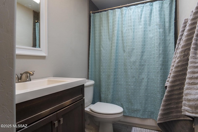 bathroom featuring toilet and vanity