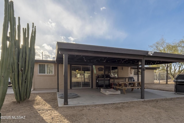 back of property with a patio