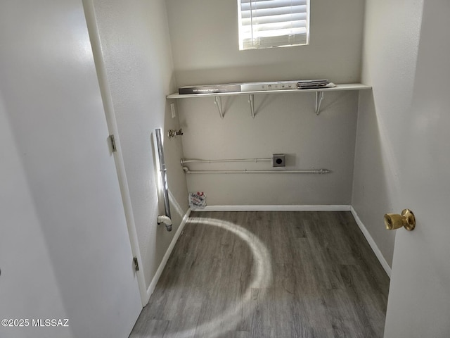 laundry area featuring baseboards, hookup for an electric dryer, wood finished floors, and laundry area