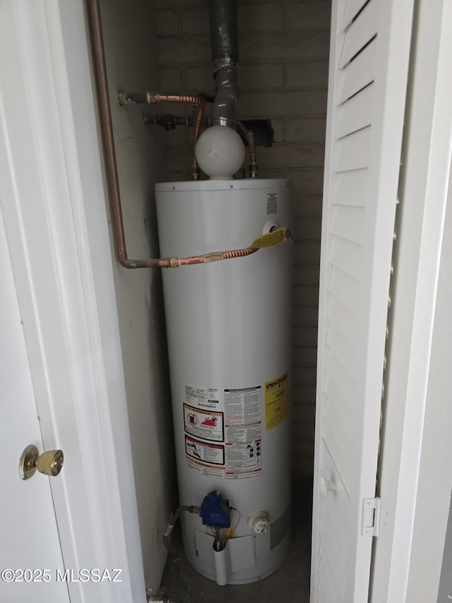 utility room with gas water heater