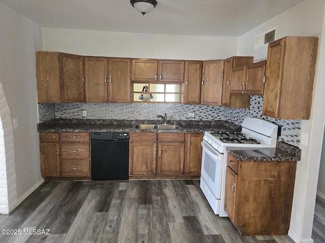 kitchen featuring brown cabinets, dishwasher, white gas range oven, and a sink