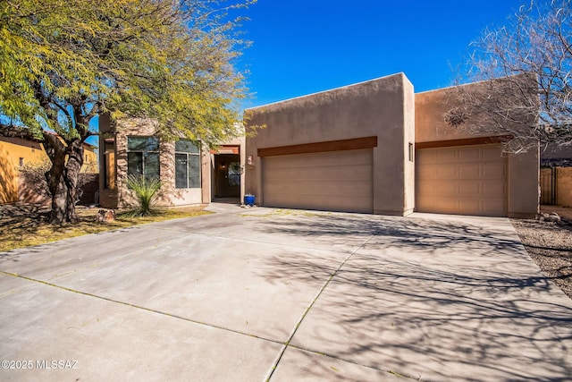 13955 E Fiery Dawn Dr, Vail, AZ 85641 - pueblo revival-style home featuring a garage, concrete driveway, and stucco siding
