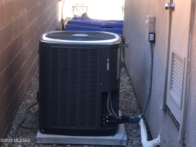 exterior details featuring stucco siding and central air condition unit