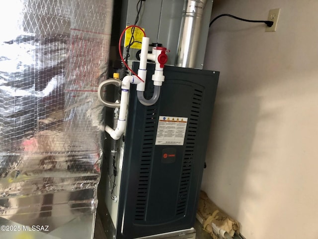 utility room featuring heating unit