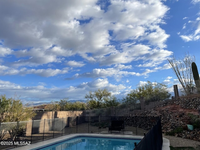 view of swimming pool featuring fence and a fenced in pool