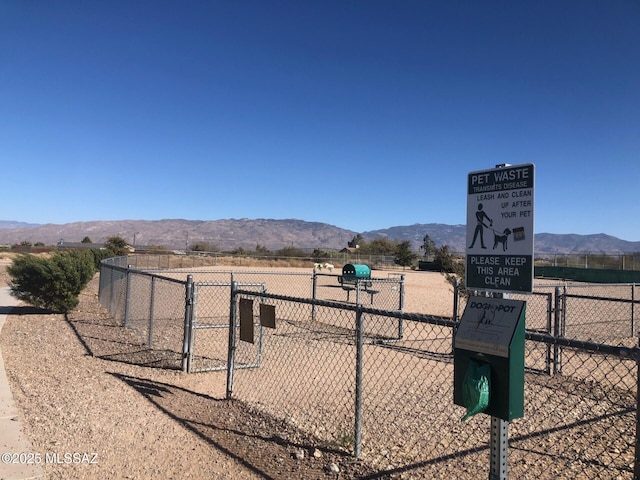 view of home's community with a mountain view and fence