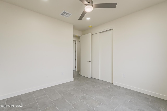 unfurnished bedroom featuring a ceiling fan, baseboards, visible vents, and a closet