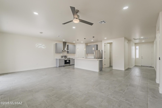 unfurnished living room featuring visible vents, baseboards, recessed lighting, a ceiling fan, and a sink