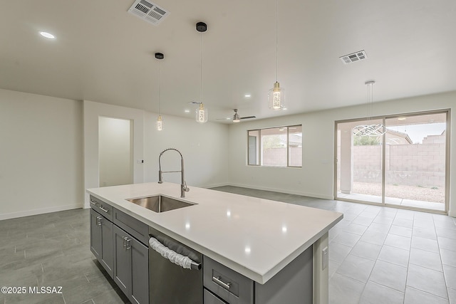 kitchen with visible vents, gray cabinets, and a sink