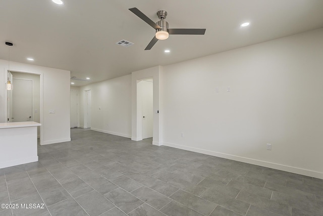 spare room featuring recessed lighting, a ceiling fan, visible vents, and baseboards