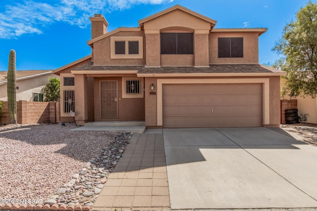 traditional-style home featuring a garage, fence, driveway, and stucco siding