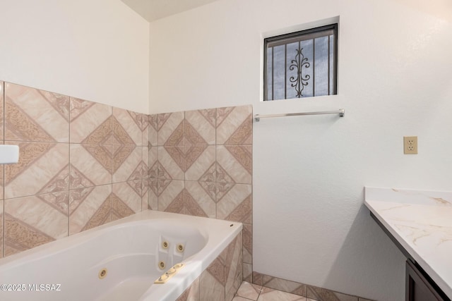 bathroom with a tub with jets and vanity