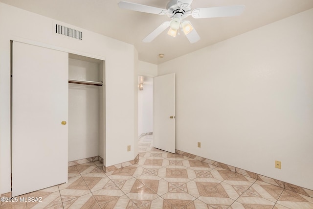 unfurnished bedroom featuring light tile patterned floors, a ceiling fan, visible vents, and a closet