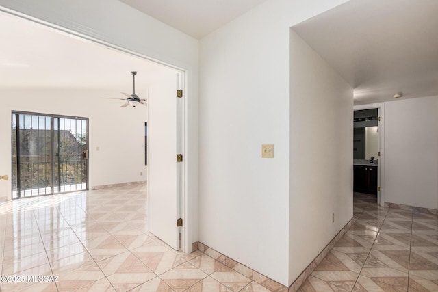 hall featuring baseboards and marble finish floor