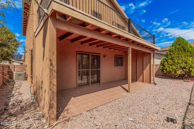 view of patio / terrace with central air condition unit and fence