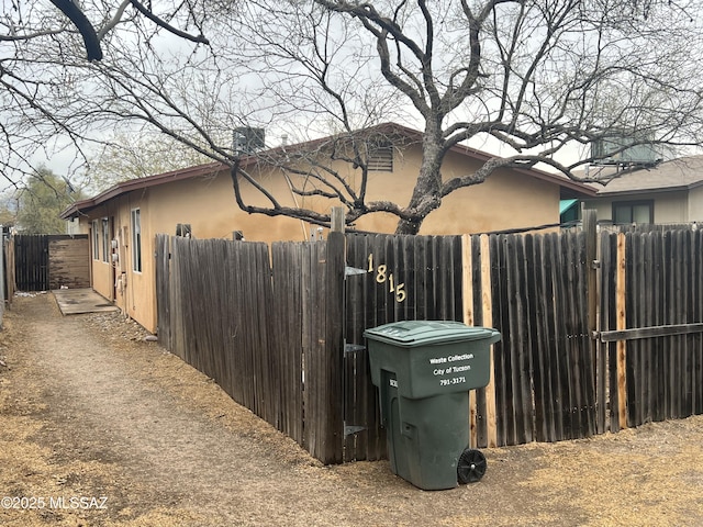 view of home's exterior featuring fence and stucco siding